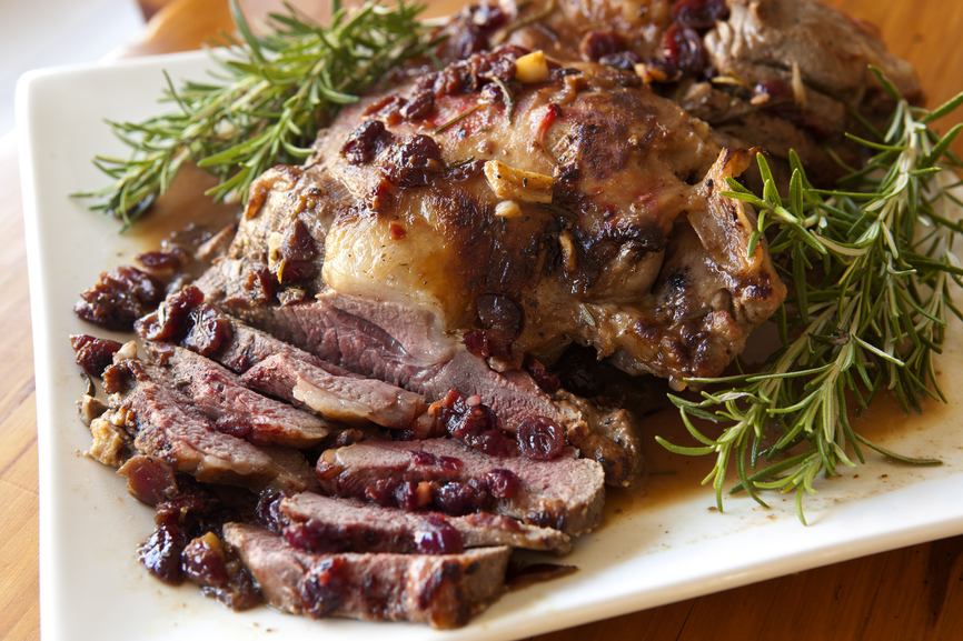 Lamb roasted with rosemary, cranberries and garlic.