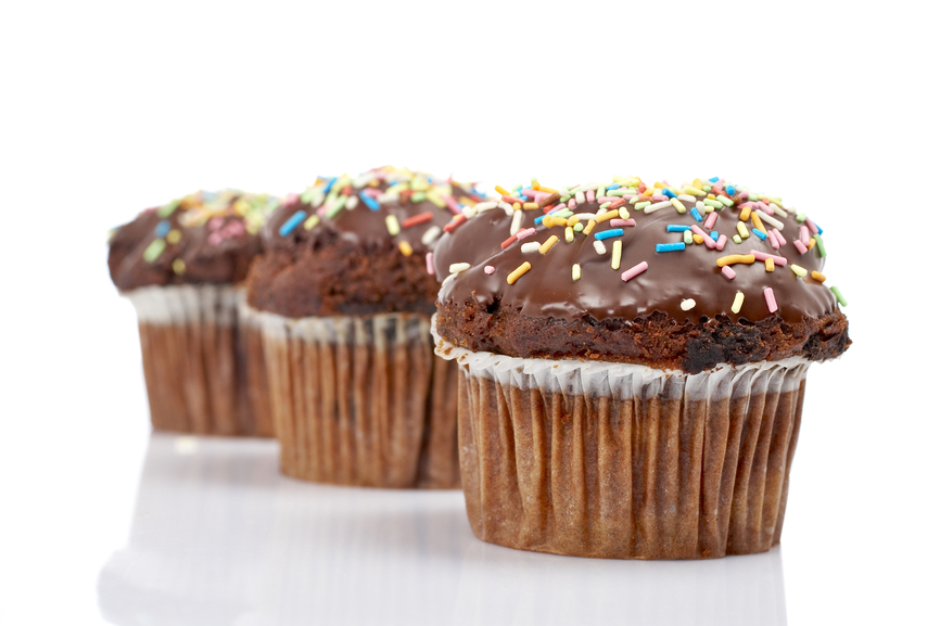 A three tasty muffin with chocolate, isolated on white background. Shallow DOF